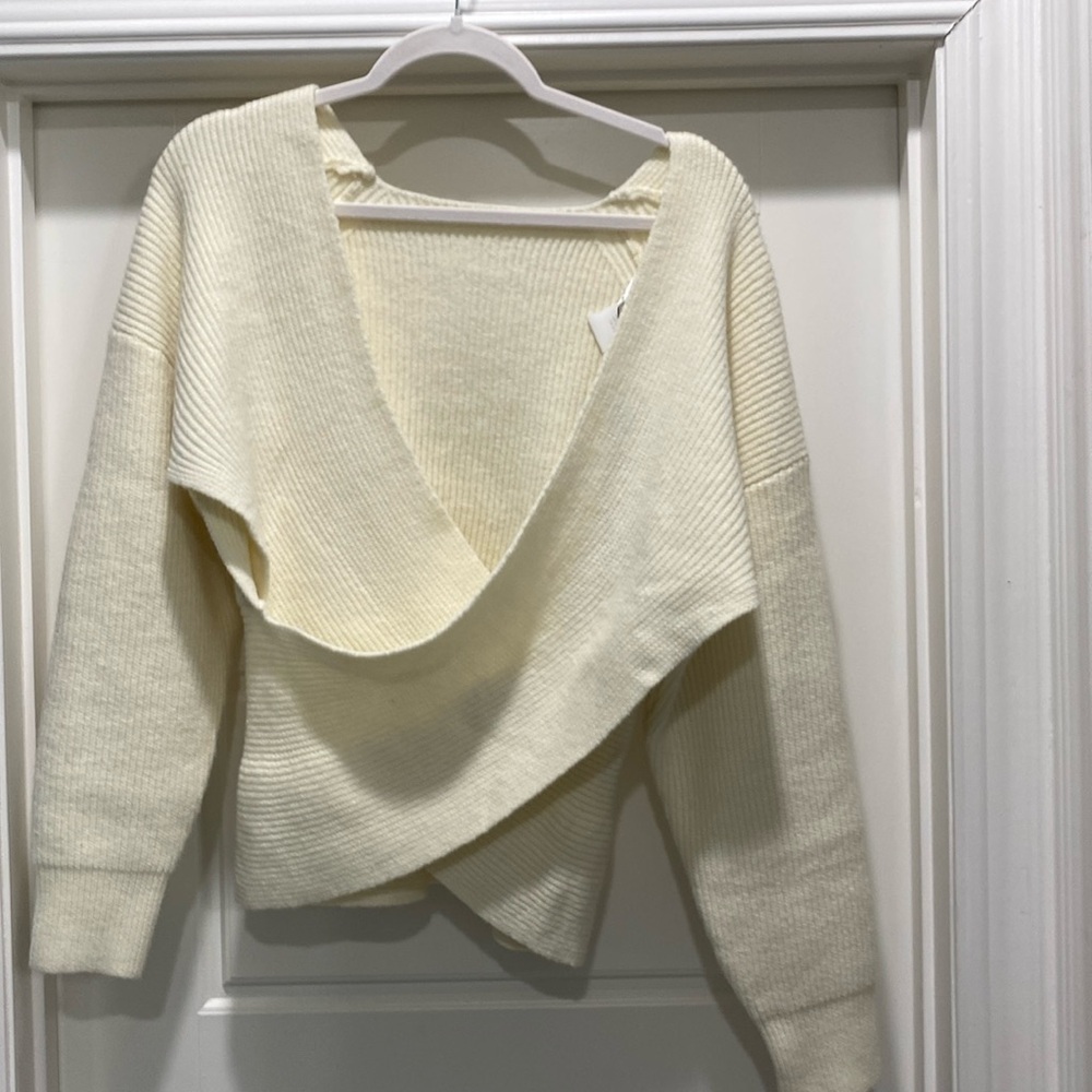 Cream, short, crossed over.